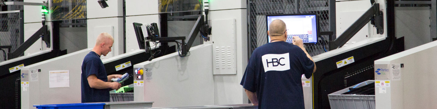 Two men working at HBC packaging and facility centre