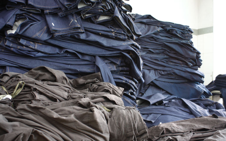 Large pile of jeans during manufacturing process